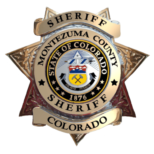 Montezuma County Sheriff's badge: a gold seven-point star with banners reading "Sheriff," "Montezuma County," "Sheriff" and "Colorado" around the State of Colorado seal, dated 1876.