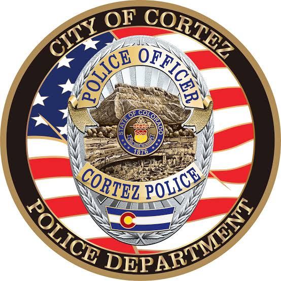 Cortez Police Department emblem: a police officer badge over an American flag, ringed by the words City of Cortez Police Department.