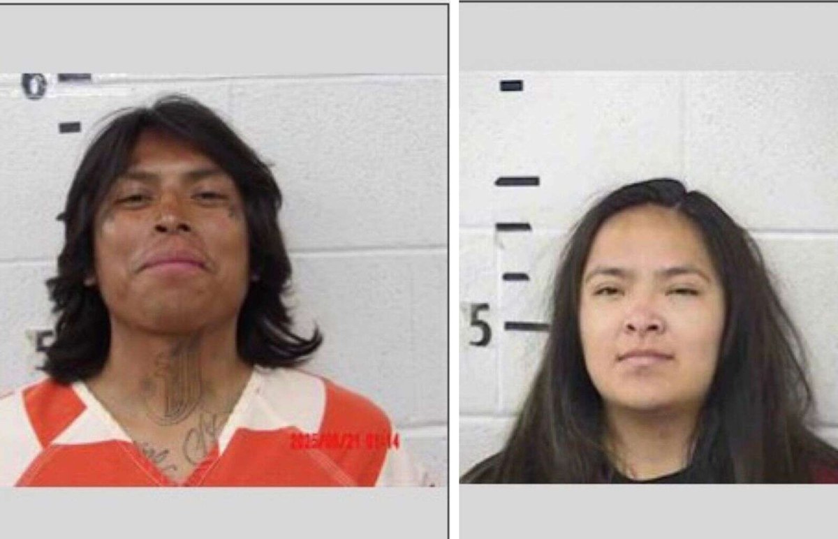 Side-by-side Montezuma County Jail booking photos of Robert Salt Jr., a man with long dark hair in orange-and-white jail stripes, and Nykhona Holiday, a woman with long dark hair in a black shirt, each against a white block wall with a height chart.