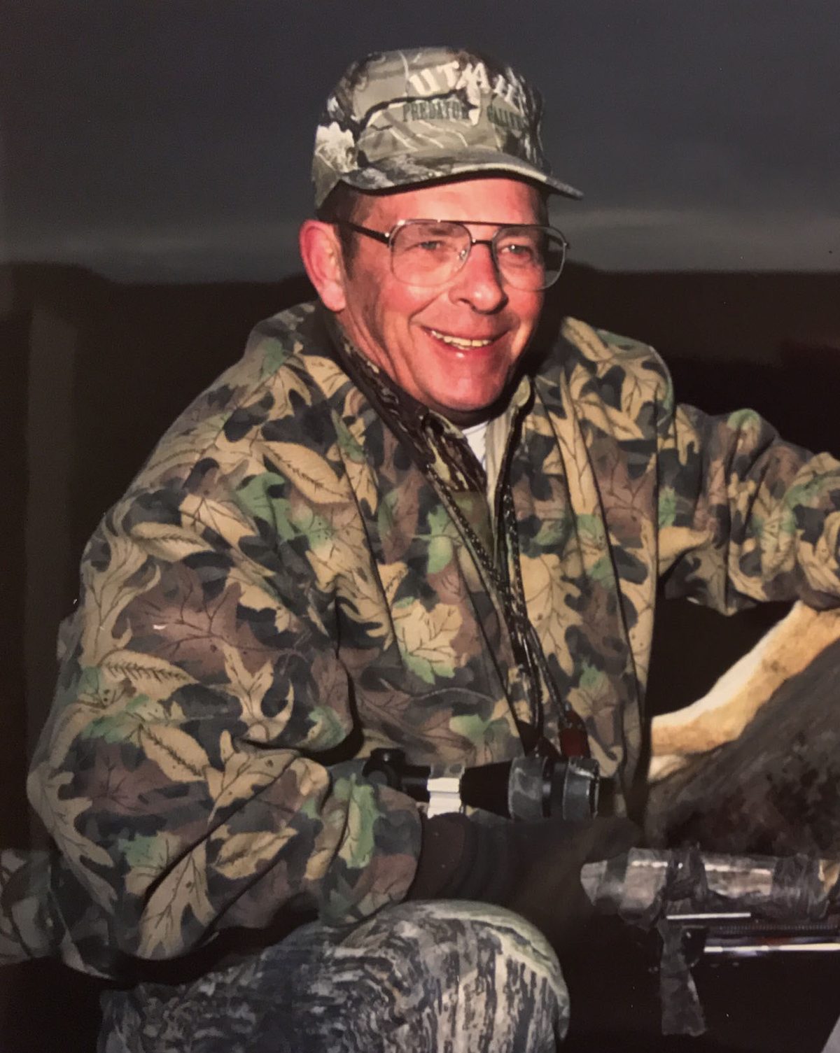 Bill Countess, smiling, in a camouflage jacket and cap